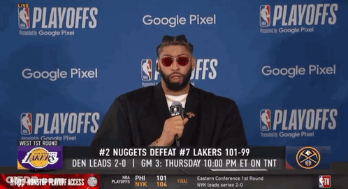 A Man Stands In Front Of A Google Pixel Banner During The Nba Playoffs GIF