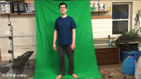 A Man Stands In Front Of A Green Screen GIF