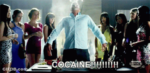 A Man Stands In Front Of A Group Of Women With The Words Cocaine Written On The Screen GIF