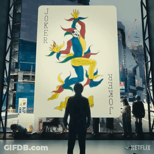A Man Stands In Front Of A Joker Card GIF