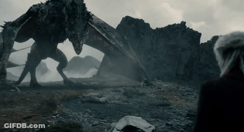 A Man Stands In Front Of A Large Dragon GIF