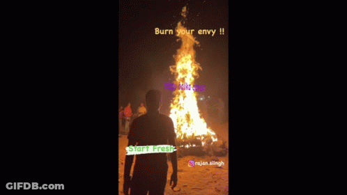 A Man Stands In Front Of A Large Fire With The Words Burn Your Envy On It GIF