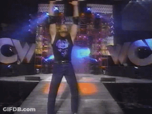 A Man Stands In Front Of A Large Wow Sign GIF