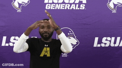 A Man Stands In Front Of A Lsu Generals Sign GIF