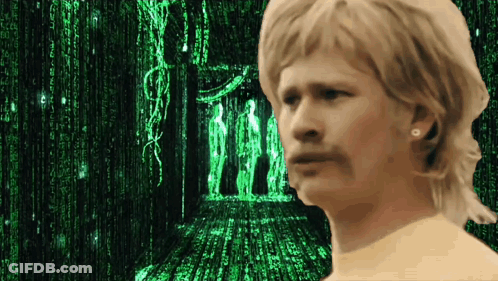 A Man Stands In Front Of A Matrix Screen GIF