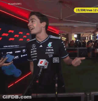 A Man Stands In Front Of A Microphone Wearing A Shirt That Says Ubs On It GIF