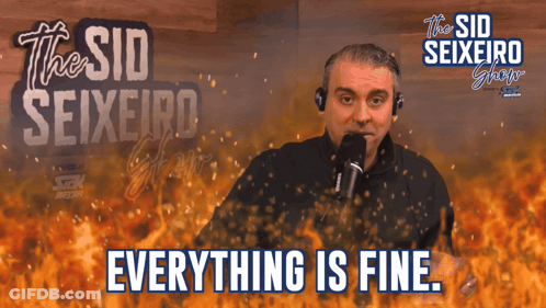 A Man Stands In Front Of A Microphone With The Words Everything Is Fine Below Him GIF