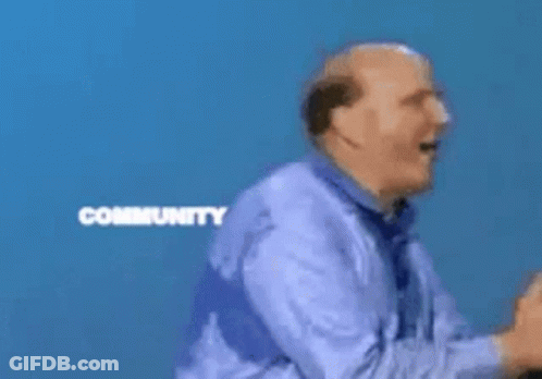 A Man Stands In Front Of A Microsoft Community Windows Sign GIF