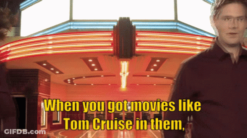 A Man Stands In Front Of A Movie Theater With The Words " When You Got Movies Like Tom Cruise In Them " GIF
