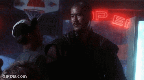 A Man Stands In Front Of A Neon Sign That Says Pepsi GIF