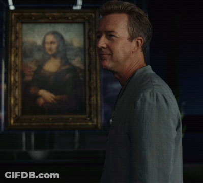 A Man Stands In Front Of A Painting Of A Woman GIF