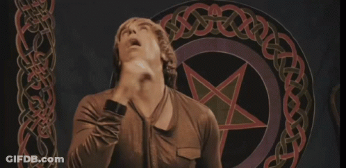 A Man Stands In Front Of A Pentagram With A Celtic Knot Around It GIF