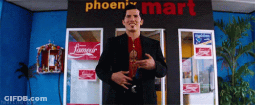 A Man Stands In Front Of A Phoenix Mart GIF