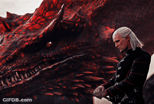 A Man Stands In Front Of A Red Dragon GIF