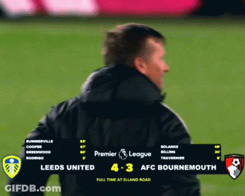 A Man Stands In Front Of A Scoreboard For A Premier League Game GIF