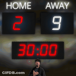 A Man Stands In Front Of A Scoreboard That Reads Home 29 Away GIF