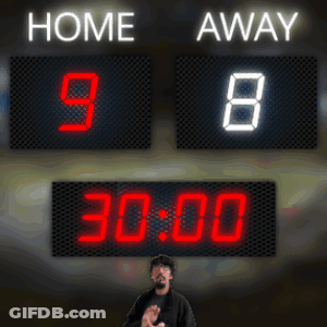 A Man Stands In Front Of A Scoreboard That Reads Home 98 Away 05:59 GIF