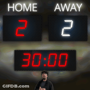 A Man Stands In Front Of A Scoreboard That Says Home 2 And Away 2 GIF