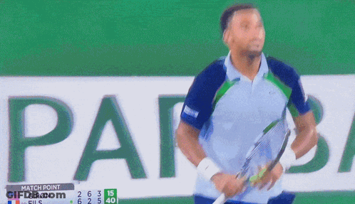 A Man Stands In Front Of A Scoreboard That Says " Match Point " GIF