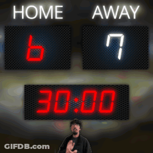 A Man Stands In Front Of A Scoreboard Which Says Home And Away GIF