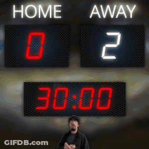 A Man Stands In Front Of A Scoreboard Which Says Home And Away GIF