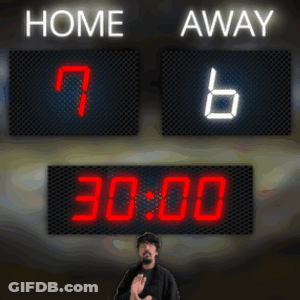 A Man Stands In Front Of A Scoreboard With Home And Away Written On It GIF