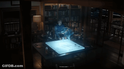 A Man Stands In Front Of A Screen That Says ' Avengers ' GIF