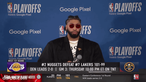 A Man Stands In Front Of A Screen That Says ' Playoffs ' On It GIF