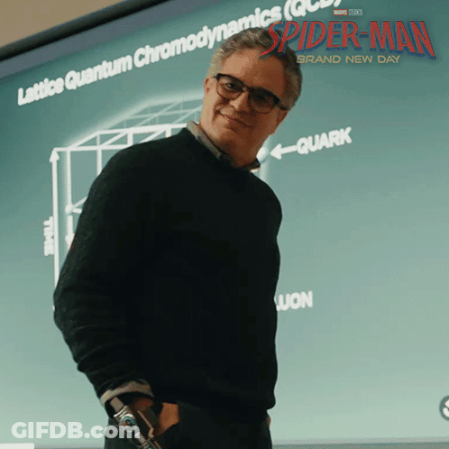 A Man Stands In Front Of A Screen That Says Spider-Man GIF