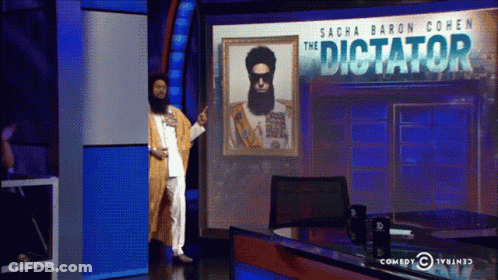 Man Standing In Front Of The Dictator Screen GIF