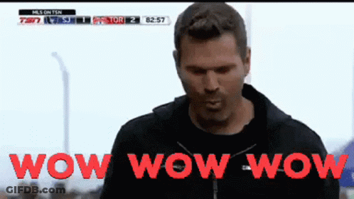Man Standing In Front Of Wow Wow Wow Screen GIF