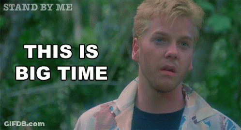 A Man Stands In Front Of A Sign That Reads This Is Big Time GIF