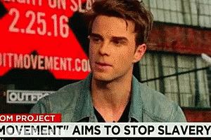 A Man Stands In Front Of A Sign That Says 2.25.16 GIF