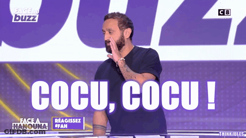 A Man Stands In Front Of A Sign That Says Cocu GIF