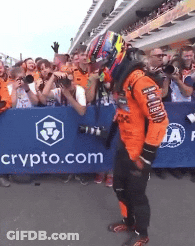 A Man Stands In Front Of A Sign That Says Crypto.com On It GIF