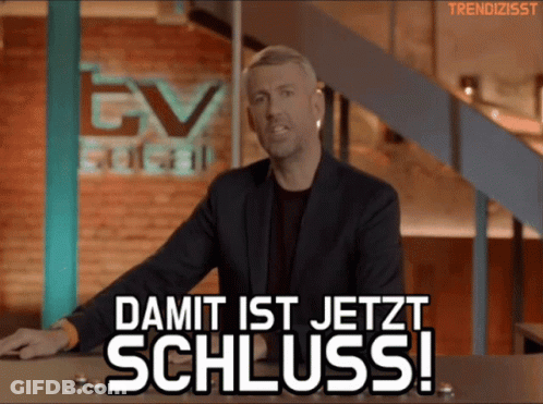 A Man Stands In Front Of A Sign That Says Damit Ist Jetzt Schluss ! GIF