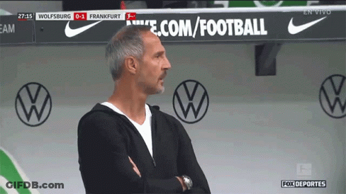 A Man Stands In Front Of A Sign That Says Ecom/football GIF
