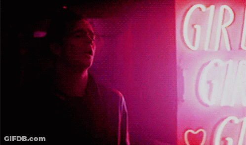 A Man Stands In Front Of A Sign That Says Girl GIF