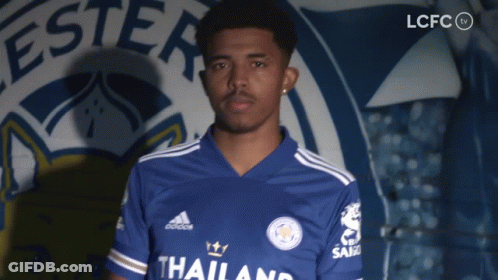 A Man Stands In Front Of A Sign That Says Lcfc On It GIF