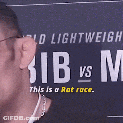 A Man Stands In Front Of A Sign That Says Lightweight Bib Vs M. GIF