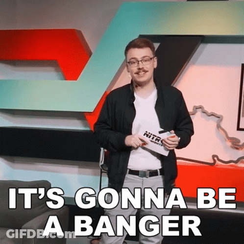 A Man Stands In Front Of A Sign That Says Nitro GIF