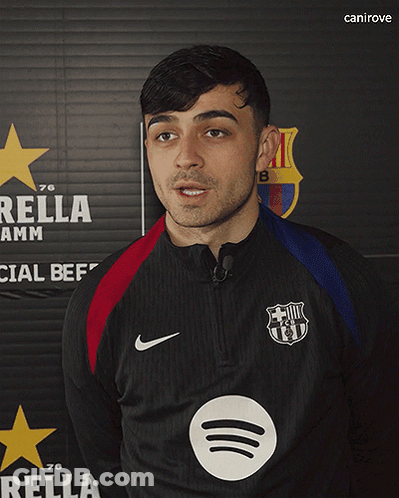 A Man Stands In Front Of A Sign That Says Rella GIF