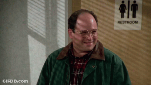 A Man Stands In Front Of A Sign That Says Restroom GIF