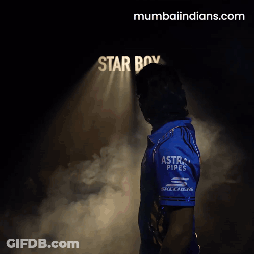 A Man Stands In Front Of A Sign That Says Star Boy On It GIF