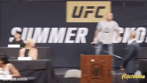 A Man Stands In Front Of A Sign That Says Ufc On It GIF