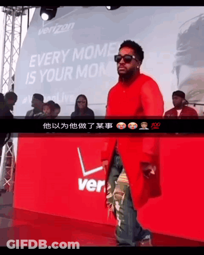 A Man Stands In Front Of A Sign That Says Verizon GIF