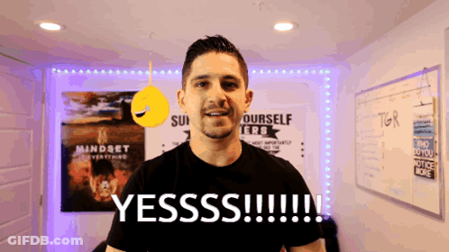 A Man Stands In Front Of A Sign That Says Yesss !!! GIF