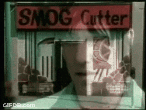 A Man Stands In Front Of A Smog Cutter Shop GIF