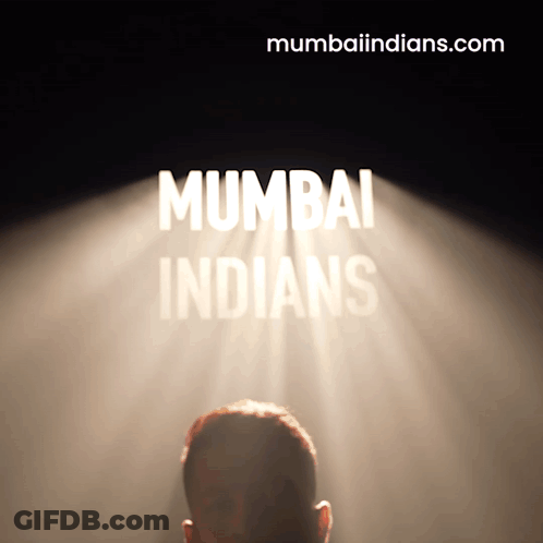 A Man Stands In Front Of A Spotlight That Says Mumbai Indians On It GIF