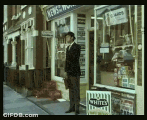 A Man Stands In Front Of A Store That Sells Whites Cigarettes GIF